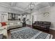 Spacious living room flows into modern kitchen, with coffered ceilings and stylish lighting creates an inviting atmosphere at 2713 Tunstall Grove Dr, Apex, NC 27523
