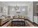 A cozy living room is decorated with comfortable furnishings, natural light, and an eye-catching rug at 2713 Tunstall Grove Dr, Apex, NC 27523