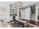 Open-concept living space with modern lighting, staircase, white cabinets, and a wine cooler adds a touch of luxury at 2713 Tunstall Grove Dr, Apex, NC 27523