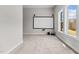 Spacious living room with a movie screen, neutral walls, plush carpet, and a bright window view at 2713 Tunstall Grove Dr, Apex, NC 27523