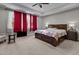 Spacious main bedroom with a large bed, ceiling fan, and ample natural light from the large window at 2713 Tunstall Grove Dr, Apex, NC 27523