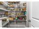 Organized pantry with ample shelving, providing convenient storage for groceries and kitchen essentials at 2713 Tunstall Grove Dr, Apex, NC 27523