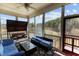 Inviting screened porch featuring comfortable seating, a ceiling fan, and serene views of the outdoors at 2713 Tunstall Grove Dr, Apex, NC 27523