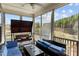 Comfortable screened porch features a plush swing and outdoor seating, offering a relaxing space to enjoy nature at 2713 Tunstall Grove Dr, Apex, NC 27523