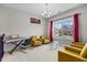 Bright sitting room with a keyboard, modern glass tables, and comfortable yellow armchairs at 2713 Tunstall Grove Dr, Apex, NC 27523