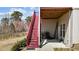 Exterior staircase with a grill and lawn equipment on the concrete patio below at 2713 Tunstall Grove Dr, Apex, NC 27523