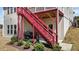 Exterior staircase leading from the deck to the backyard patio with a grill at 2713 Tunstall Grove Dr, Apex, NC 27523