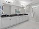 Elegant bathroom featuring a dual sink vanity, granite countertops, and tiled shower at 288 Whispering Wind Dr, Chapel Hill, NC 27516