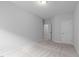 This bedroom has light-grey walls, carpet, one window and two doorways at 288 Whispering Wind Dr, Chapel Hill, NC 27516
