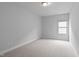Bright bedroom showcasing neutral walls, plush carpeting, and natural light at 288 Whispering Wind Dr, Chapel Hill, NC 27516