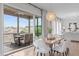Bright dining room with modern light fixture, table and chairs, and screened-in porch at 288 Whispering Wind Dr, Chapel Hill, NC 27516