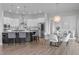Open concept kitchen and dining area with white cabinets, stainless steel appliances and modern lighting at 288 Whispering Wind Dr, Chapel Hill, NC 27516