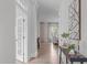 Bright entryway with hardwood floors and decorative console table, and view to living space at 288 Whispering Wind Dr, Chapel Hill, NC 27516