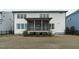 Rear exterior view highlighting the screened porch and fenced backyard with a mix of grass and mulch at 288 Whispering Wind Dr, Chapel Hill, NC 27516