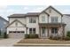 Charming two-story home with a covered front porch and an attached two-car garage at 288 Whispering Wind Dr, Chapel Hill, NC 27516