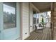 Inviting covered front porch with chairs and wooden flooring, perfect for relaxing at 288 Whispering Wind Dr, Chapel Hill, NC 27516