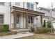 Inviting covered front porch with stone support columns and ample seating space at 288 Whispering Wind Dr, Chapel Hill, NC 27516