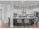 Kitchen island with bar seating, pendant lights, and stainless steel appliances at 288 Whispering Wind Dr, Chapel Hill, NC 27516