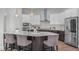 Kitchen island with bar seating, pendant lights, and stainless steel appliances at 288 Whispering Wind Dr, Chapel Hill, NC 27516
