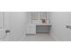 The laundry room has a sink, vanity, and grey tiling at 288 Whispering Wind Dr, Chapel Hill, NC 27516