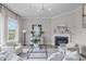 Bright living room boasts fireplace, modern lighting, and stylish decor at 288 Whispering Wind Dr, Chapel Hill, NC 27516