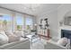 Bright living room boasts large windows, fireplace, modern lighting, and stylish decor at 288 Whispering Wind Dr, Chapel Hill, NC 27516