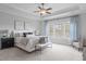 Spacious main bedroom with a tray ceiling, fan, and natural light at 288 Whispering Wind Dr, Chapel Hill, NC 27516