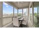 Inviting screened porch with a ceiling fan, stylish dining set, and views of the backyard at 288 Whispering Wind Dr, Chapel Hill, NC 27516