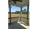 Covered back porch overlooks a lovely open field at 2915 Cox Mill Rd, Sanford, NC 27332