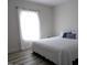 Bright bedroom with white bedding and natural light from a large window at 2915 Cox Mill Rd, Sanford, NC 27332