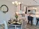 Open-concept dining area with a stylish table setting, adjacent to a modern kitchen at 2915 Cox Mill Rd, Sanford, NC 27332
