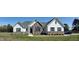Charming new construction home featuring stone accents, a gray roof, and a well-manicured lawn at 2915 Cox Mill Rd, Sanford, NC 27332