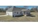 The exterior of this well-maintained home features a rear covered porch and attached garage at 2915 Cox Mill Rd, Sanford, NC 27332