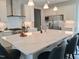 Spacious kitchen with a large island, stainless steel appliances, and elegant white cabinetry at 2915 Cox Mill Rd, Sanford, NC 27332
