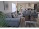 Open concept living space with modern kitchen and dining area, featuring gray sofas at 2915 Cox Mill Rd, Sanford, NC 27332