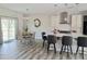 Bright, open-concept living space with kitchen, dining area, and access to an outdoor patio at 2915 Cox Mill Rd, Sanford, NC 27332