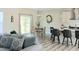 Open-concept living space featuring a comfortable sofa, dining area, and modern kitchen at 2915 Cox Mill Rd, Sanford, NC 27332