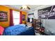 Lively bedroom with orange accents, sports memorabilia, and space for personalization, designed for comfort and style at 3014 Split Wood Ct, Oxford, NC 27565