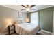 Cozy bedroom with a ceiling fan, a large window, and neutral wall colors at 3014 Split Wood Ct, Oxford, NC 27565