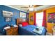 Colorful bedroom with unique decorations, including sports-themed wall art and a ceiling fan at 3014 Split Wood Ct, Oxford, NC 27565