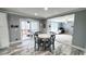The dining area has wood-look floors, a glass door to a deck, and seating for four at 3014 Split Wood Ct, Oxford, NC 27565