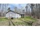 View of the side and back of the home with deck and large lot with mature trees at 3014 Split Wood Ct, Oxford, NC 27565