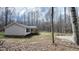 View of the side of the home with yard, landscaping and mature trees in a wooded lot at 3014 Split Wood Ct, Oxford, NC 27565
