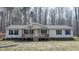 Charming single-story home with a welcoming front porch and beautiful surroundings at 3014 Split Wood Ct, Oxford, NC 27565