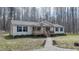 Charming one story home with front porch, landscaping, and a stone path at 3014 Split Wood Ct, Oxford, NC 27565