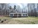 View of home exterior with inviting porch and surrounded by lush trees at 3014 Split Wood Ct, Oxford, NC 27565