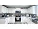 Bright kitchen featuring stainless appliances, backsplash, stone countertops, and white cabinets at 3014 Split Wood Ct, Oxford, NC 27565