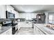 Modern kitchen with white cabinets, stainless steel appliances, and a stylish island at 3014 Split Wood Ct, Oxford, NC 27565