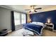 Inviting main bedroom with a large window, neutral carpet, and a stylish color accent wall at 3014 Split Wood Ct, Oxford, NC 27565