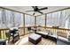 Covered screened-in porch with comfortable seating and a grill, perfect for outdoor relaxation at 3014 Split Wood Ct, Oxford, NC 27565